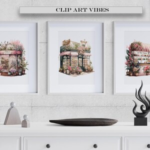 May include: Three framed watercolour paintings of pink floral shops with white trim and green plants. The paintings are hung on a grey concrete wall above a white shelf with three grey concrete sculptures and a black wooden tray.