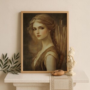May include: A framed portrait of a woman with long, braided blonde hair and a classical-style dress. The artwork features a soft color palette with warm tones. A quiver of arrows is visible behind her. The portrait is displayed on a white surface.