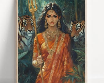 May include: A framed art print featuring a woman in an orange sari holding a gold trident, flanked by two tigers in a lush green forest. The woman wears gold jewelry and has a red bindi on her forehead. The artwork has a painterly style.