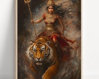May include: A framed art print depicts a woman in gold and red attire riding a tiger. She holds a golden trident. The artwork has a painterly style with a dark, atmospheric background. The tiger is orange and black.