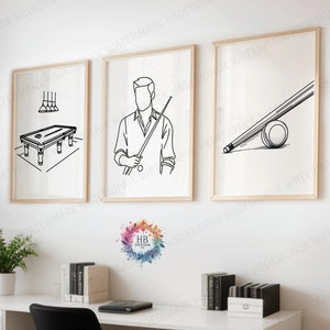 May include: Three black and white line drawings of a pool table, a person holding a pool cue, and a pool cue and ball. The drawings are framed and hung on a white wall above a desk with a black office chair.