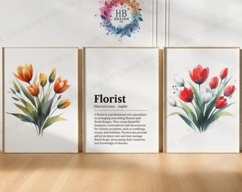May include: A triptych of framed floral art prints. The prints display watercolour illustrations of flowers in orange, red, and white. The central print features the definition of "Florist". The frames are light brown.