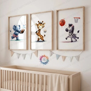 May include: Three watercolour illustrations of animals playing sports. An elephant wearing a red, white and blue outfit is holding a football. A giraffe wearing a baseball cap is holding a baseball bat. A zebra is dribbling a basketball.