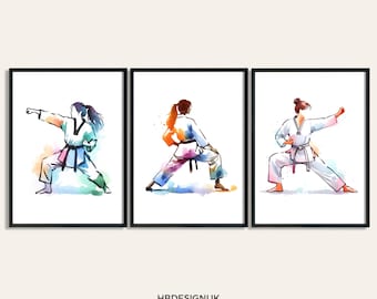 May include: Three framed art prints featuring watercolor illustrations of individuals in white martial arts uniforms performing various stances. The artwork displays vibrant splashes of blue, green, orange, and red paint. Text at the bottom reads HBDESIGNUK ART PRINTS ON ETSY.