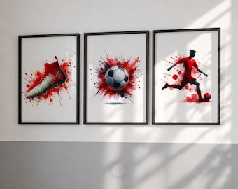 May include: A set of three framed wall art prints featuring soccer themes. The left print shows a red and white soccer cleat, the center print displays a soccer ball, and the right print depicts a soccer player in motion, all with red paint splatters.