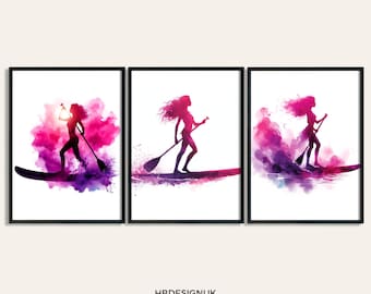 May include: Three watercolor paintings of women paddleboarding. Each painting features a silhouette of a woman paddleboarding on a wave with pink and purple watercolor splashes.