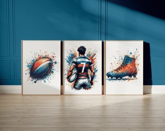 May include: Three framed prints with a watercolor-style design. The first print features a rugby ball with orange, blue, and white splashes. The second print features a rugby player wearing a blue and orange jersey with the name "Adam" and the number "7" on the back. The third print features a black and orange rugby boot with white laces.