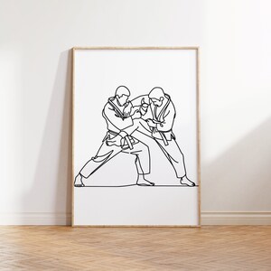 Peut inclure: Dessin au trait de deux personnes en position de combat d'arts martiaux. Les figures sont dessin&eacute;es en un seul trait continu.