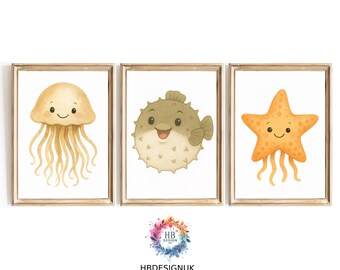May include: Three framed prints featuring cartoon sea creatures. The first print shows a yellow jellyfish with a smiling face. The second print shows a brown and white pufferfish with a smiling face. The third print shows a yellow starfish with a smiling face.