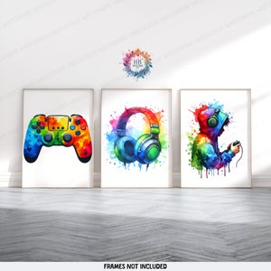 May include: Three watercolour paintings with a gamer theme. The first painting features a colourful video game controller. The second painting features a pair of colourful headphones. The third painting features a person wearing a colourful hoodie and headphones holding a video game controller.