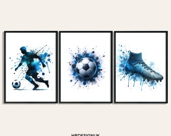 May include: A set of three framed art prints featuring blue watercolor-style illustrations of a soccer player dribbling a ball, a centered soccer ball, and a soccer cleat. The text HBDESIGNUK ART PRINTS ON ETSY appears at the bottom center.