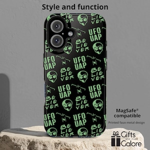 May include: Black phone case with a repeating pattern of green alien heads and the text "UFO UAP" and "BE LIE VER".