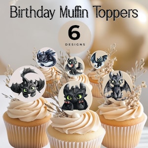 May include: Cupcakes topped with dragon-themed birthday muffin toppers. The toppers feature six different dragon designs in black, gray, and green. The cupcakes have a swirl of light brown frosting and are decorated with dried sprigs.
