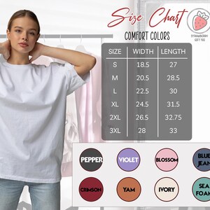 a woman wearing a white t-shirt, posing in front of a size chart for comfort colors.