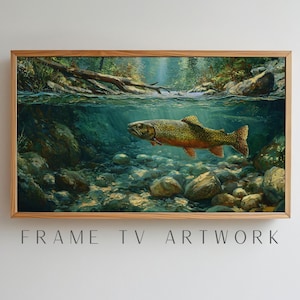 May include: A framed artwork depicting a trout swimming in a clear stream. The painting shows the fish underwater with a rocky riverbed and a forest in the background. The frame is made of wood. The text "FRAME TV ARTWORK" is at the bottom.
