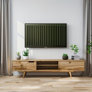 May include: A light wood TV stand with two drawers and open shelves. The stand has a modern design with tapered legs. There are two potted plants and a stack of books on top of the stand. A flat screen TV is mounted on the wall above the stand.