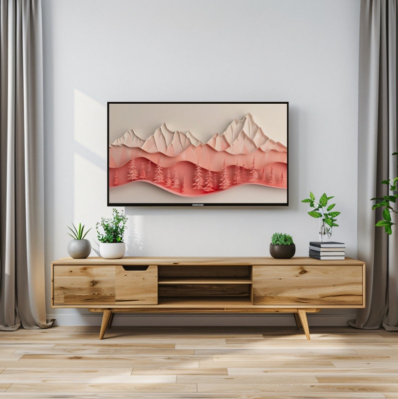 May include: A wooden TV stand with two drawers and an open shelf. The stand is light brown and has a modern design. A flat screen TV is mounted on the wall above the stand. The TV screen shows a digital art image of a mountain range with a pink and white color scheme.