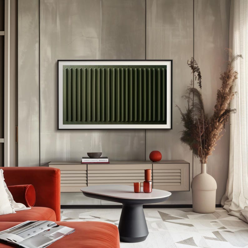 May include: A modern living room interior with a large flat screen TV displaying a green abstract image, a red sofa, a wooden cabinet with a white top, a round coffee table with a white top and black base, a vase with dried flowers, and a red bowl on the cabinet.