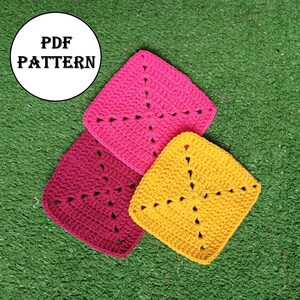May include: Three crocheted squares in pink, burgundy, and yellow. The squares are laid out on a green surface. The text "PDF PATTERN" is in a white circle on the top left of the image.