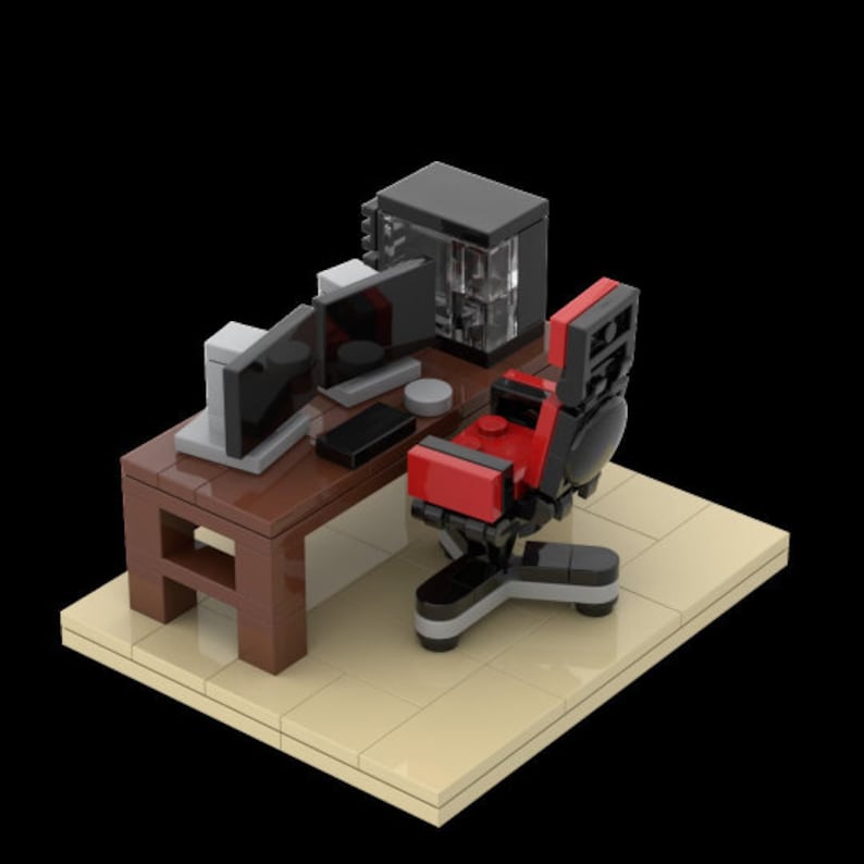May include: A Lego model of a gaming setup with a black computer tower, two monitors, a brown desk, and a red and black gaming chair.