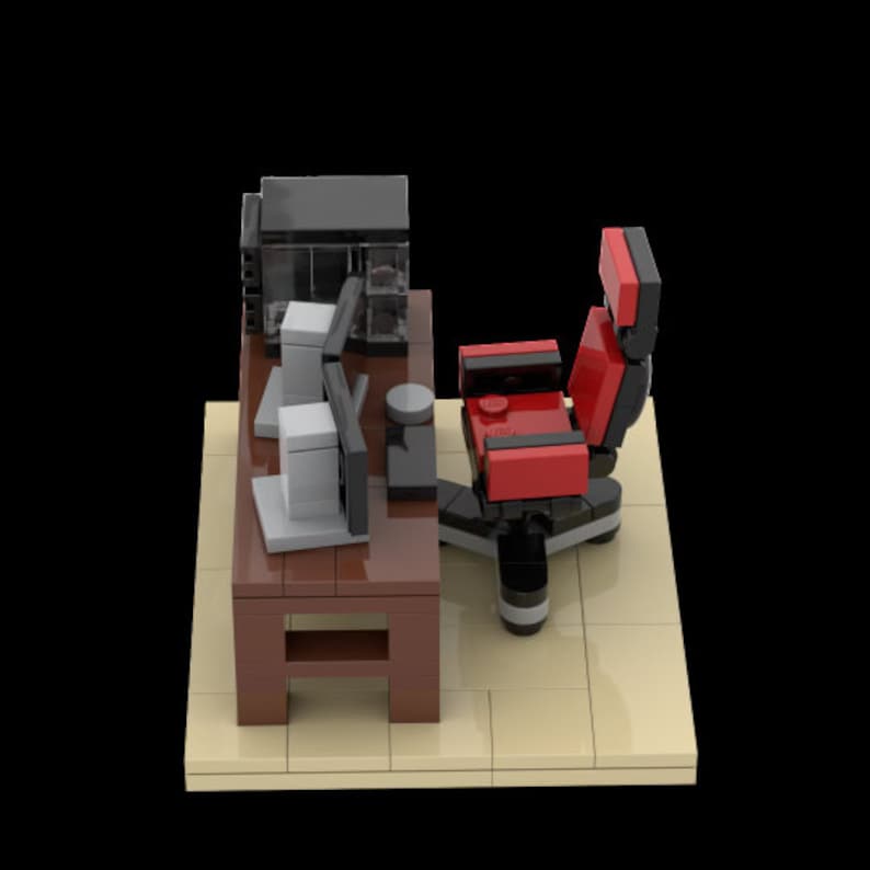 May include: A red and black office chair with a black computer desk and two gray computer monitors. The desk has a brown top and a shelf underneath.