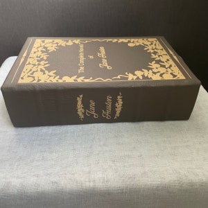 May include: A brown leather-bound book with gold lettering. The title is "The Complete Novels of Jane Austen".