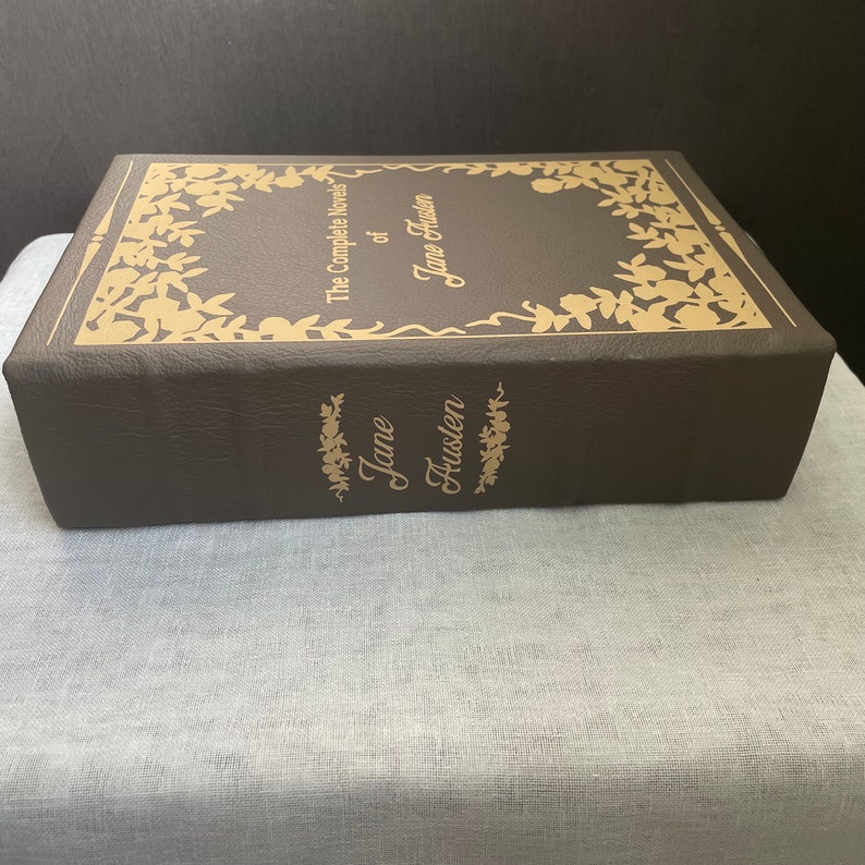 May include: A brown leather-bound book with gold lettering. The title is "The Complete Novels of Jane Austen".