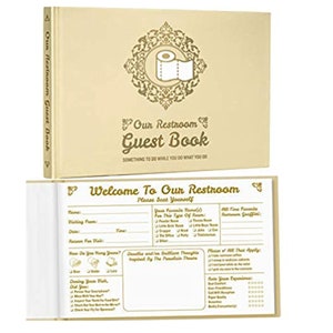 May include: A beige guest book titled "Our Restroom Guest Book" with a decorative toilet paper roll graphic. The open book reveals fill-in-the-blank prompts for guests. The cover text reads "Something to do while you do what you do."