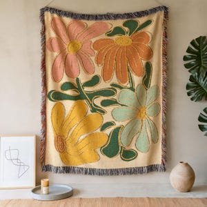 Boho flower woven blanket with vintage large floral design in earthy tones.  Showns 4 large flowers in retro style design in earth tone colors.  Perfect as  tapestry, throw for sofa, bed, or wall hanging,  Beige color shown here as a wall tapestry.