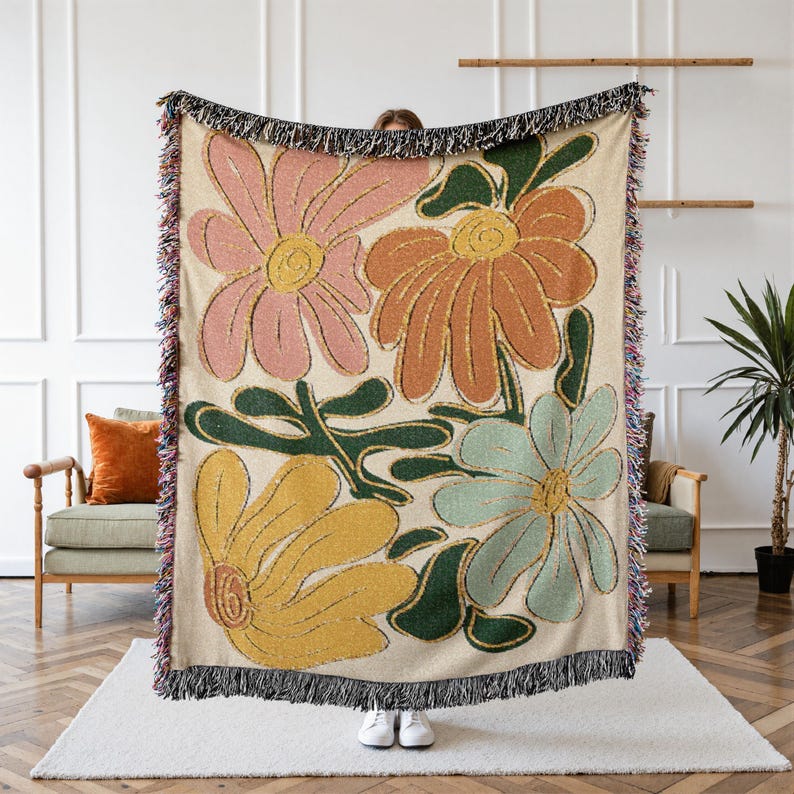 Boho flower woven blanket with vintage large floral design in earthy tones.  Showns 4 large flowers in retro style design in earth tone colors.  Perfect as  tapestry, throw for sofa, bed, or wall hanging,  Beige color shown here being held up by a person.