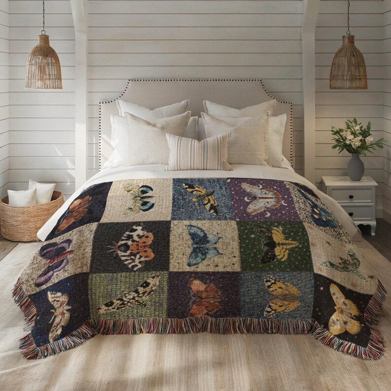 Celestial moth woven blanket shown here as bedding.