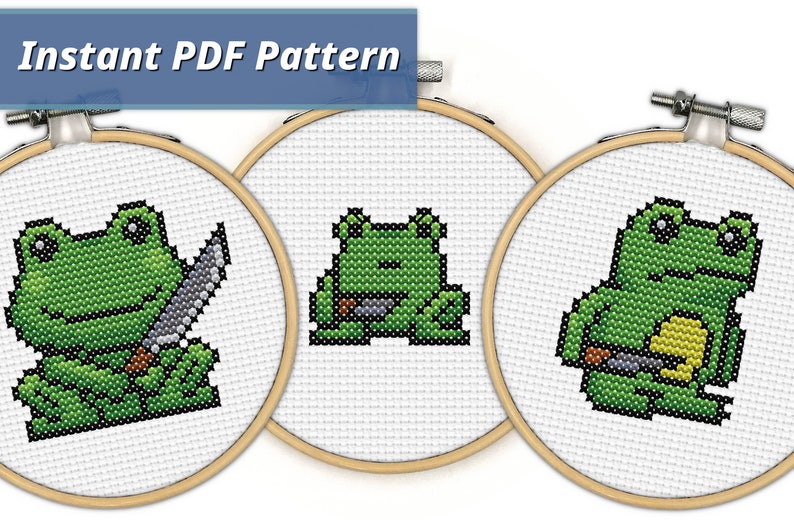 May include: Three cross-stitch patterns featuring green frogs with black eyes. The frogs are holding knives and are in different poses. The patterns are in embroidery hoops.