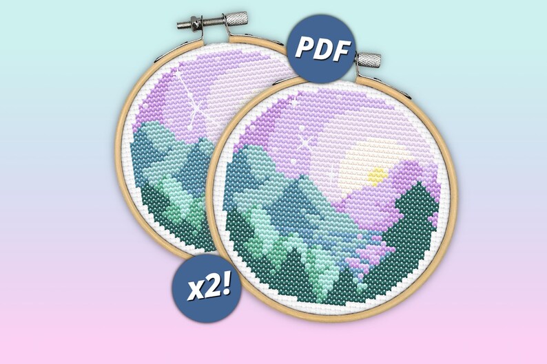 May include: Two circular wooden embroidery hoops containing cross-stitch patterns of a mountain landscape at sunset. The designs feature shades of purple, blue, and green with a yellow sun. A blue circular icon with the text PDF and another with x2!.