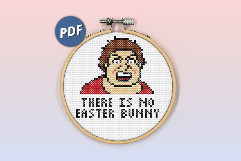 May include: A cross-stitch pattern in a circular wooden embroidery hoop featuring a pixelated character with brown hair and a red shirt. Below the character, the black text reads: THERE IS NO EASTER BUNNY. A blue circular icon with the white text PDF is visible.