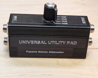 Almohadilla de utilidad universal TRS/TS de 1/4", atenuador conmutable