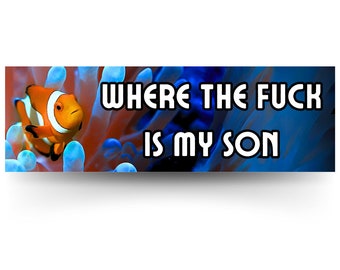 May include: A close-up of an orange and white clownfish swimming in a blue and red coral reef. The text "WHERE THE FUCK IS MY SON" is written in white letters on a black background.