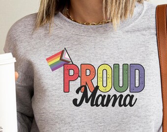 May include: A gray sweatshirt with a rainbow pride flag and the text "PROUD Mama" in rainbow colors.