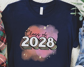 May include: A navy blue t-shirt with a colorful graphic that says "Class of 2028" on a pink and blue watercolor background.