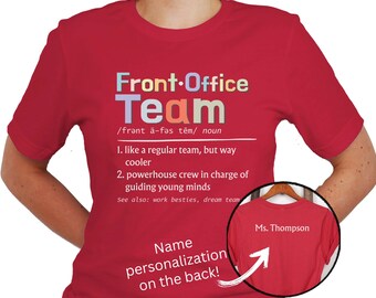 May include: Red t-shirt with the text "Front Office Team" defined as "like a regular team, but way cooler" and "powerhouse crew in charge of guiding young minds". The text is in a rainbow font. The back of the shirt has the text "Name personalization on the back!" and "Ms. Thompson" written in white.