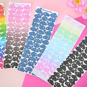 May include: Six sheets of cloud stickers with different color gradients and patterns. The stickers feature a cloud design with white stars. The sheets are labeled "Kawineko".
