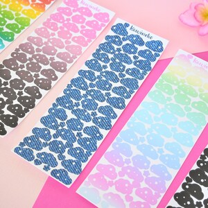 May include: Six sheets of cloud-shaped stickers with different patterns. The patterns include rainbow, pink, denim, light blue, and black. The stickers are labeled "Kawineko".
