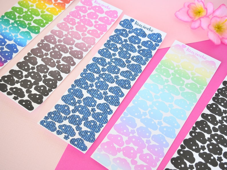 May include: Six sheets of cloud-shaped stickers with different patterns. The patterns include rainbow, pink, denim, light blue, and black. The stickers are labeled "Kawineko".
