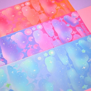 May include: Three sheets of iridescent holographic stickers featuring clouds and stars in shades of pink, blue, and orange. The stickers are labeled "Kawaiiverse".