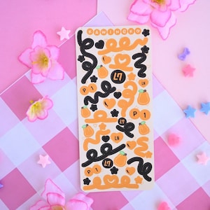 May include: A sheet of stickers with a peach theme. The stickers feature peaches, hearts, and the text "Kawaii Nekko".