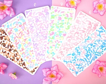 Hojas adhesivas de cintas decorativas con colores degradados y pequeñas decoraciones.