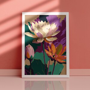 May include: A framed print of a stylized floral illustration featuring three white, pink, and orange lotus flowers with green leaves on a dark green background.