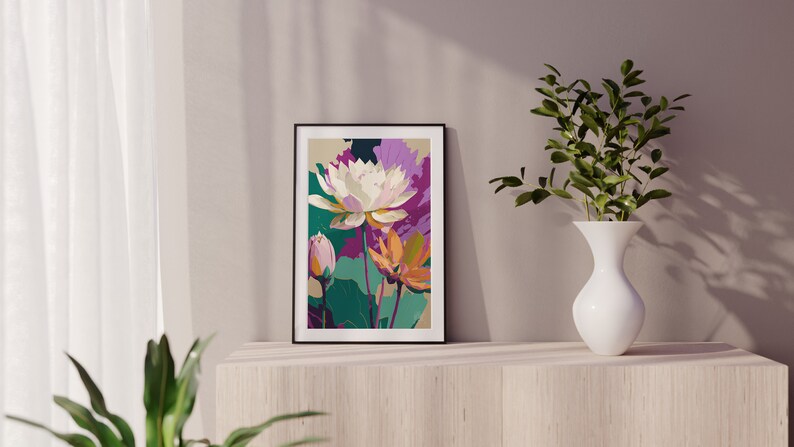 May include: A framed print of a colorful floral illustration featuring white, pink, orange, and green flowers. The print is in a black frame and is hanging on a light wood shelf.