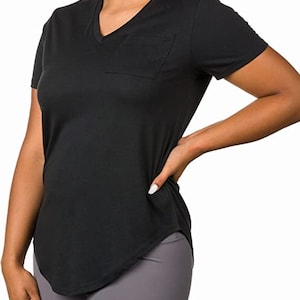 May include: Black short-sleeved v-neck t-shirt with a curved hem and a single pocket on the left side.