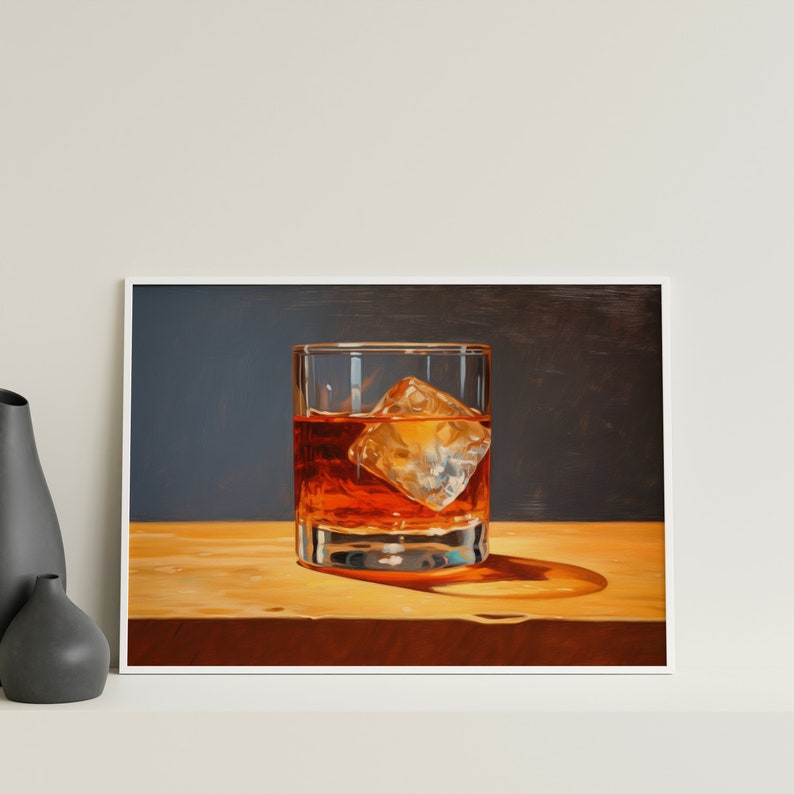 May include: A glass of amber-colored liquid with a single ice cube in a clear glass on a wooden surface.