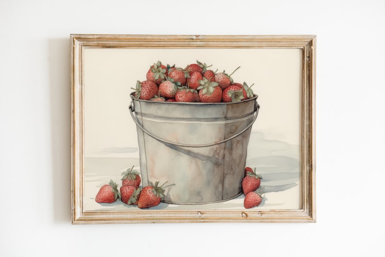 May include: A watercolor painting of a metal bucket filled with red strawberries. The bucket is sitting on a white surface with a few strawberries scattered around it.